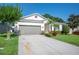 Charming single-story home with a two-car garage and manicured lawn at 4303 Moon Shadow Loop, Mulberry, FL 33860