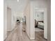 Hallway view leading into a bedroom with gray wood-look floors at 4303 Moon Shadow Loop, Mulberry, FL 33860