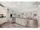 Open-concept kitchen featuring an island, stainless steel appliances, and stylish gray countertops at 4303 Moon Shadow Loop, Mulberry, FL 33860