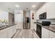 Modern kitchen with stainless steel appliances and plenty of counter space, including an island with a sink at 4303 Moon Shadow Loop, Mulberry, FL 33860