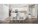 Stylish kitchen with white cabinets, grey counters, stainless steel appliances, and modern bar stools at 4303 Moon Shadow Loop, Mulberry, FL 33860