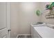 Laundry room featuring white washer and dryer, plus upper shelf at 4303 Moon Shadow Loop, Mulberry, FL 33860