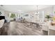 Bright living room with wood-style floors, a modern chandelier, and lots of natural light at 4303 Moon Shadow Loop, Mulberry, FL 33860