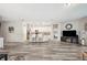 Open-concept living space with hardwood floors, seamless access to kitchen, and modern decor at 4303 Moon Shadow Loop, Mulberry, FL 33860