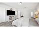 Comfortable bedroom with hardwood floors and neutral palette featuring large TV and an adjacent walk-in closet at 4303 Moon Shadow Loop, Mulberry, FL 33860