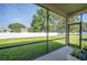 Covered screened patio with a view of the home's lush backyard and white privacy fence at 4303 Moon Shadow Loop, Mulberry, FL 33860