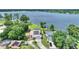 Lakefront homes featuring solar panels, lush landscaping, and private docks at 440 Lake Daisy, Winter Haven, FL 33884