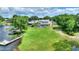 Aerial view of lakeside property with a large backyard, swimming pool, and private dock at 440 Lake Daisy, Winter Haven, FL 33884