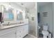 Modern bathroom with double sinks, glass shower with subway tile, and stylish fixtures at 440 Lake Daisy, Winter Haven, FL 33884