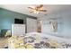 Comfortable bedroom with blue walls, a ceiling fan, a comfy bed, and a hanging chair, perfect for relaxation at 440 Lake Daisy, Winter Haven, FL 33884