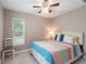 Comfortable bedroom with ceiling fan, window, and decorative pillows and comforter at 440 Lake Daisy, Winter Haven, FL 33884