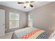 Cozy bedroom with neutral walls, ceiling fan, and a colorful patterned bedspread at 440 Lake Daisy, Winter Haven, FL 33884