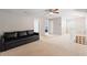 Spacious bonus room features neutral paint, carpeted floor, and an inviting couch with a ceiling fan at 440 Lake Daisy, Winter Haven, FL 33884