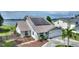 Beautiful home on the water featuring solar panels, a lush lawn, and a fenced backyard at 440 Lake Daisy, Winter Haven, FL 33884