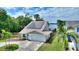 Beautiful home showcasing a two-car garage, solar panels, and waterfront views at 440 Lake Daisy, Winter Haven, FL 33884