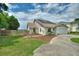Well-kept single-story home featuring a two-car garage, light blue front door, and lush green lawn at 440 Lake Daisy, Winter Haven, FL 33884