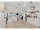 Open kitchen with white cabinets, wood-look floors, and lake view at 440 Lake Daisy, Winter Haven, FL 33884