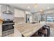 Kitchen island featuring stainless appliances, natural stone countertops, and pendant lighting at 440 Lake Daisy, Winter Haven, FL 33884
