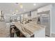 Open concept kitchen featuring breakfast bar, stainless appliances, and pendant lighting at 440 Lake Daisy, Winter Haven, FL 33884