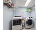 Functional laundry room with modern washer, dryer, and ample shelving for storage at 440 Lake Daisy, Winter Haven, FL 33884