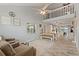 Bright, open living area with a loft, ceiling fan, and wood-look flooring at 440 Lake Daisy, Winter Haven, FL 33884