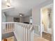 Open-concept loft area with railing, view of downstairs, and access to additional rooms at 440 Lake Daisy, Winter Haven, FL 33884