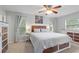 Bright main bedroom featuring a rustic bed frame, ceiling fan, and plentiful natural light at 440 Lake Daisy, Winter Haven, FL 33884