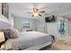 Bright main bedroom featuring a rustic bed frame, ceiling fan, backyard access, and television at 440 Lake Daisy, Winter Haven, FL 33884