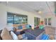 Inviting covered patio with comfortable seating, a coffee table, and scenic views of the pool and lake at 440 Lake Daisy, Winter Haven, FL 33884