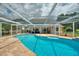 Gorgeous screened-in pool features a brick patio and spa, perfect for outdoor living and entertaining at 440 Lake Daisy, Winter Haven, FL 33884