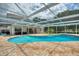 Inviting screened-in pool with a brick patio and comfortable outdoor seating, perfect for relaxation at 440 Lake Daisy, Winter Haven, FL 33884