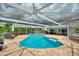 Relax in this screened-in pool with brick patio and mature landscaping, ideal for outdoor living at 440 Lake Daisy, Winter Haven, FL 33884