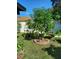 Lush backyard with a fruit tree surrounded by a brick border at 455 Eagle Dr, Kissimmee, FL 34759