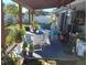 Cozy backyard patio with a covered pergola, comfortable seating, a dining area, and green surroundings at 455 Eagle Dr, Kissimmee, FL 34759