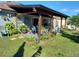 Charming backyard patio with wooden pergola, perfect for outdoor relaxation and entertaining, plus lush greenery at 455 Eagle Dr, Kissimmee, FL 34759