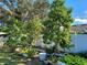 A beautiful backyard with fruit trees, garden beds and white fencing at 455 Eagle Dr, Kissimmee, FL 34759