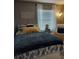 Comfortable bedroom featuring a blue and white patterned bedspread and sunny window at 455 Eagle Dr, Kissimmee, FL 34759