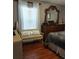 Serene bedroom with hardwood floors, large window, and a dresser, offering a peaceful retreat at 455 Eagle Dr, Kissimmee, FL 34759
