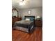 Bedroom with hardwood floors, a large dresser, and a comfortable queen-sized bed at 455 Eagle Dr, Kissimmee, FL 34759