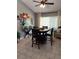 Bright dining area featuring a dark wood table, seating for four, and sliding glass doors at 455 Eagle Dr, Kissimmee, FL 34759