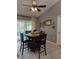 Modern dining room with seating for four and sliding glass doors to outdoor patio at 455 Eagle Dr, Kissimmee, FL 34759