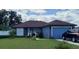 Charming single-story home with a well-maintained lawn, blue paint, and a cozy front porch at 455 Eagle Dr, Kissimmee, FL 34759