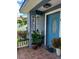 Inviting front porch with a decorated blue front door, potted plants, and a welcome sign at 455 Eagle Dr, Kissimmee, FL 34759