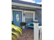 Inviting front porch with a cozy bench, potted plants, and a decorative door at 455 Eagle Dr, Kissimmee, FL 34759