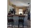 Eat-in kitchen with bar seating, white cabinets, and stainless steel appliances at 455 Eagle Dr, Kissimmee, FL 34759