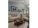 Comfortable living room with vaulted ceiling, neutral furniture, and decorative accents create a welcoming space at 455 Eagle Dr, Kissimmee, FL 34759