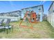 Backyard with above ground pool, play structure and shaded patio at 511 Preserve Pointe Blvd, Davenport, FL 33837