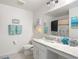 Clean bathroom features a vanity, toilet, and a shower with coastal decor at 511 Preserve Pointe Blvd, Davenport, FL 33837