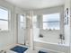 Bright bathroom featuring a walk-in shower, a separate tub, and large windows for natural light at 511 Preserve Pointe Blvd, Davenport, FL 33837
