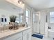 Bright bathroom featuring a double sink vanity, glass-enclosed shower, and bathtub at 511 Preserve Pointe Blvd, Davenport, FL 33837